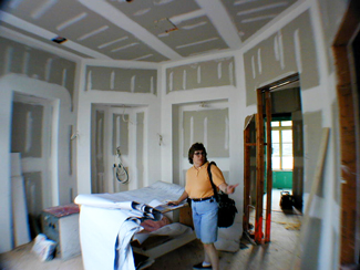 "Fisheye lens view of Audra Frank working at a large installation".  